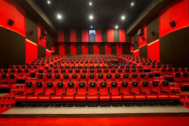 Inside one of the halls at Alappuzha — rows of red seats under a red and black wall